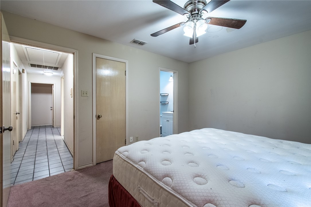 4502 Marie Street Corpus Christi, TX 78411 - Photo 20 of 26 a large bedroom with a bed and a chandelier