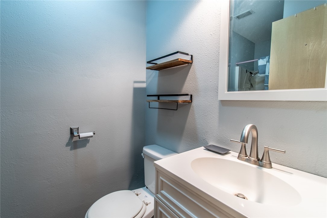 4502 Marie Street Corpus Christi, TX 78411 - Photo 21 of 26 a bathroom with a sink mirror vanity and toilet
