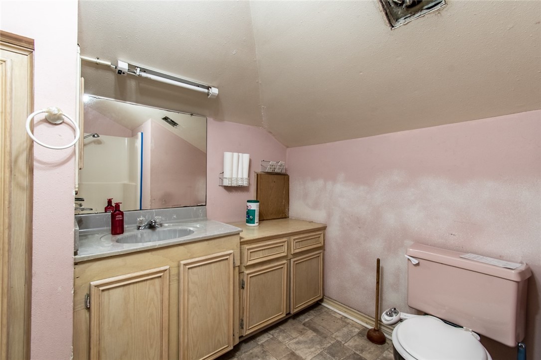 4502 Marie Street Corpus Christi, TX 78411 - Photo 23 of 26 a bathroom with a granite countertop sink mirror vanity and toilet