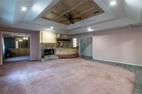 a view of an empty room with a fireplace and a window