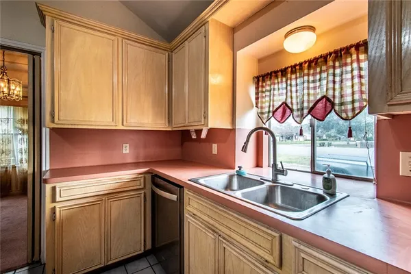 a kitchen with stainless steel appliances granite countertop a sink and a microwave