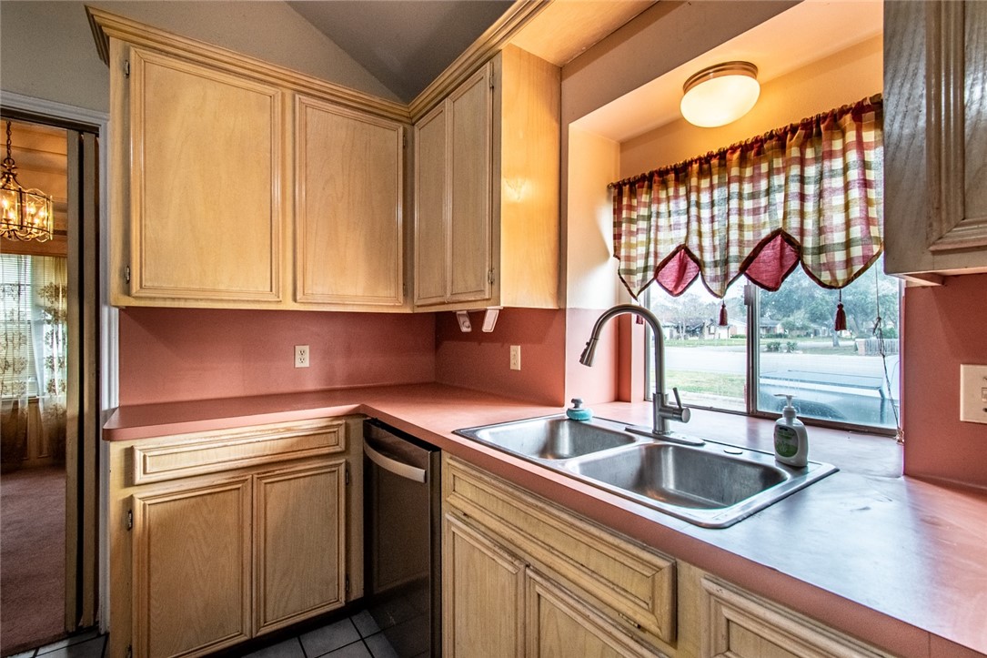 4502 Marie Street Corpus Christi, TX 78411 - Photo 7 of 26 a kitchen with stainless steel appliances granite countertop a sink and a microwave