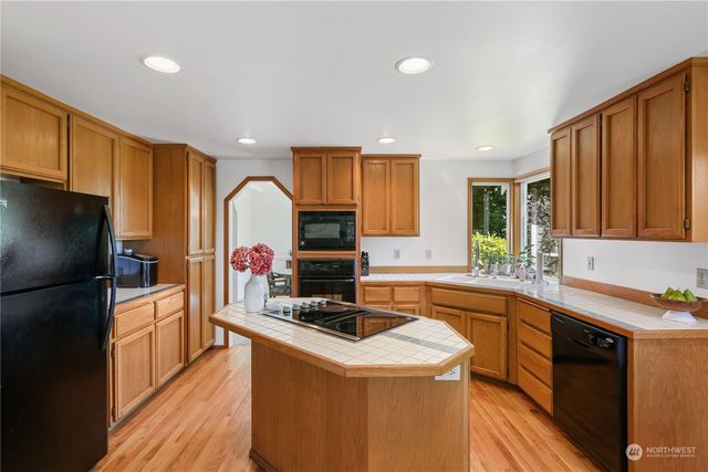 a kitchen that has a sink and a stove in it