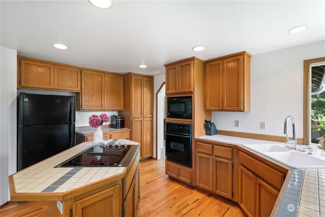 a kitchen with a sink stove and refrigerator