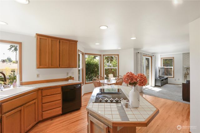 a kitchen with a stove a sink and cabinets