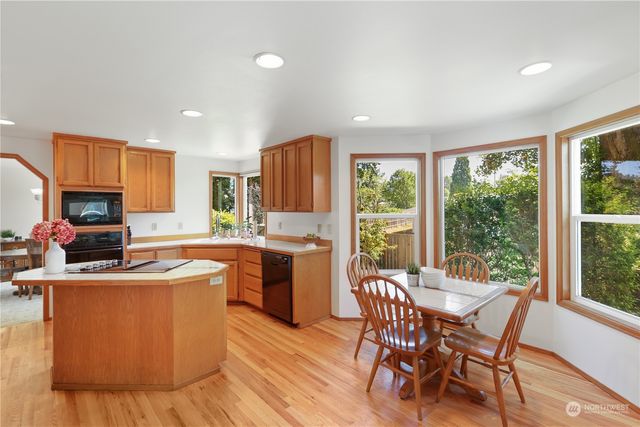 a kitchen with stainless steel appliances granite countertop sink stove top oven and cabinets