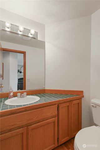 a bathroom with a sink a toilet and mirror