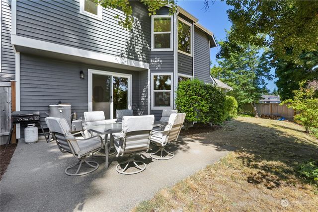 a view of a patio with table and chairs and potted plants