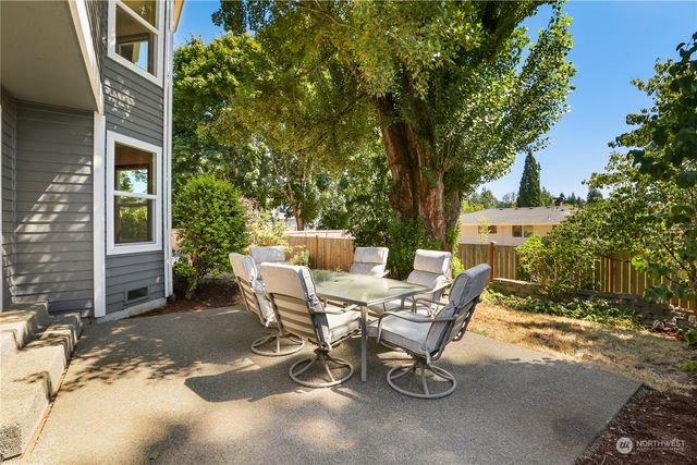 a view of a patio with table and chairs and potted plants