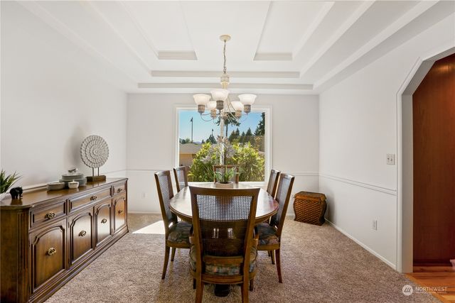 a view of a dining room with furniture and chandelier