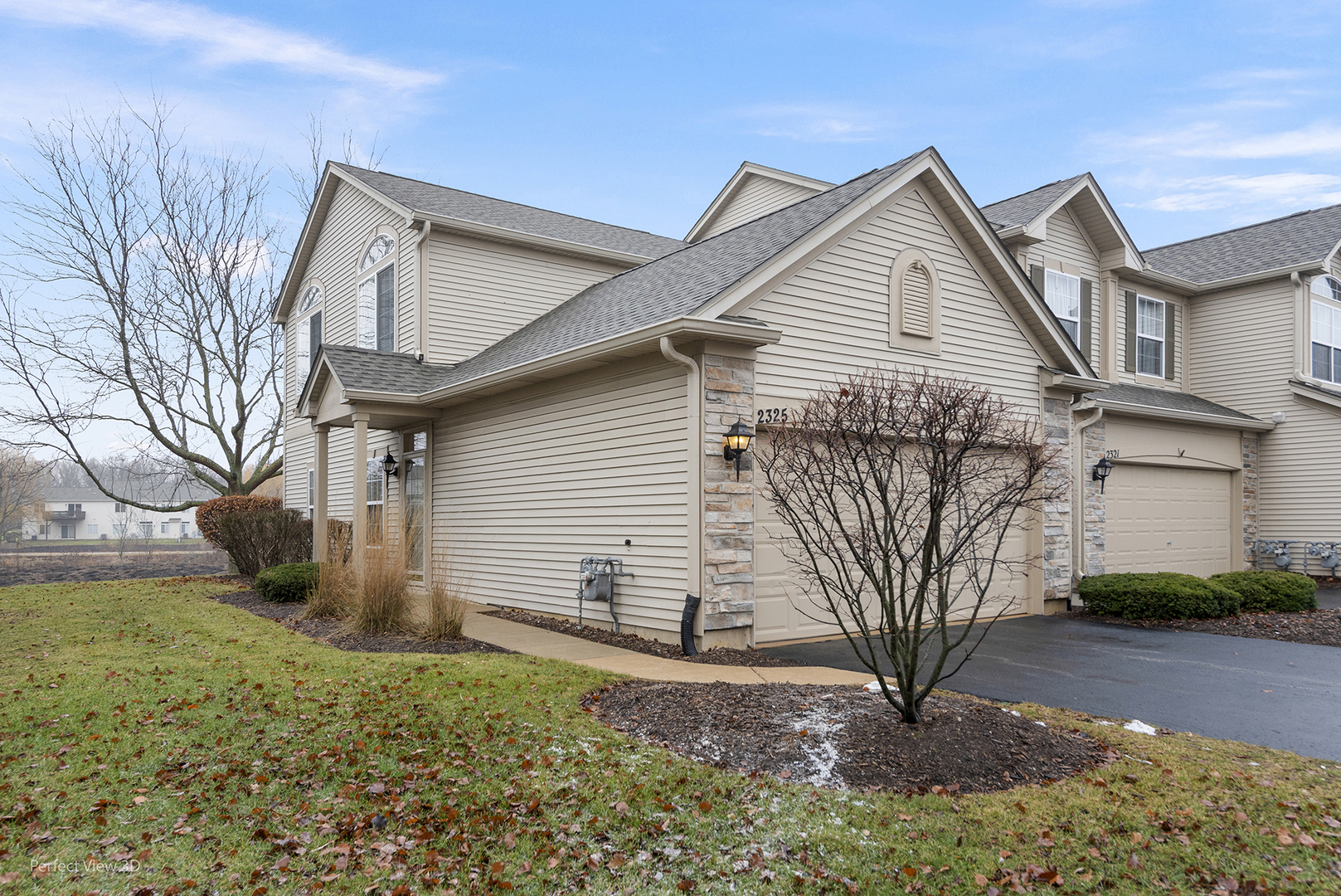 2325 Summerlin Drive, Unit 2325 Aurora, IL 60503 - Photo 1 of 20 a front view of a house with a yard and garage