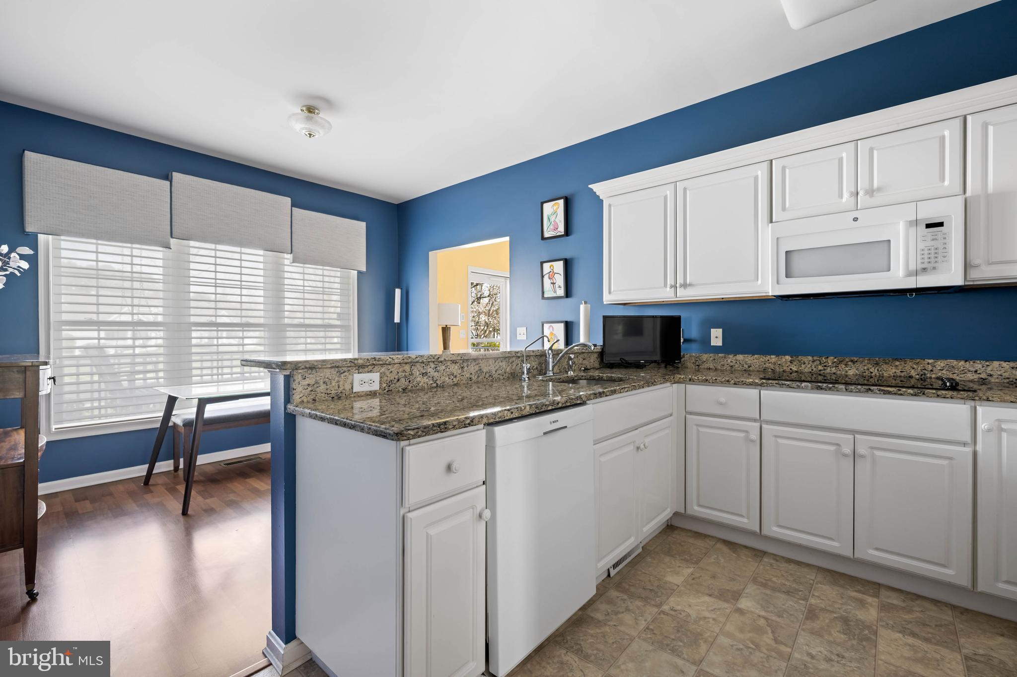 929 Winding Way Salisbury, MD 21804 - Photo 10 of 31 a kitchen with granite countertop sink cabinets and wooden floor