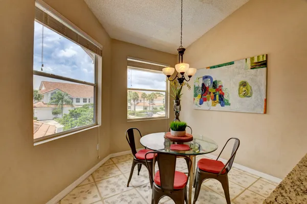 a dining room with furniture a chandelier and window
