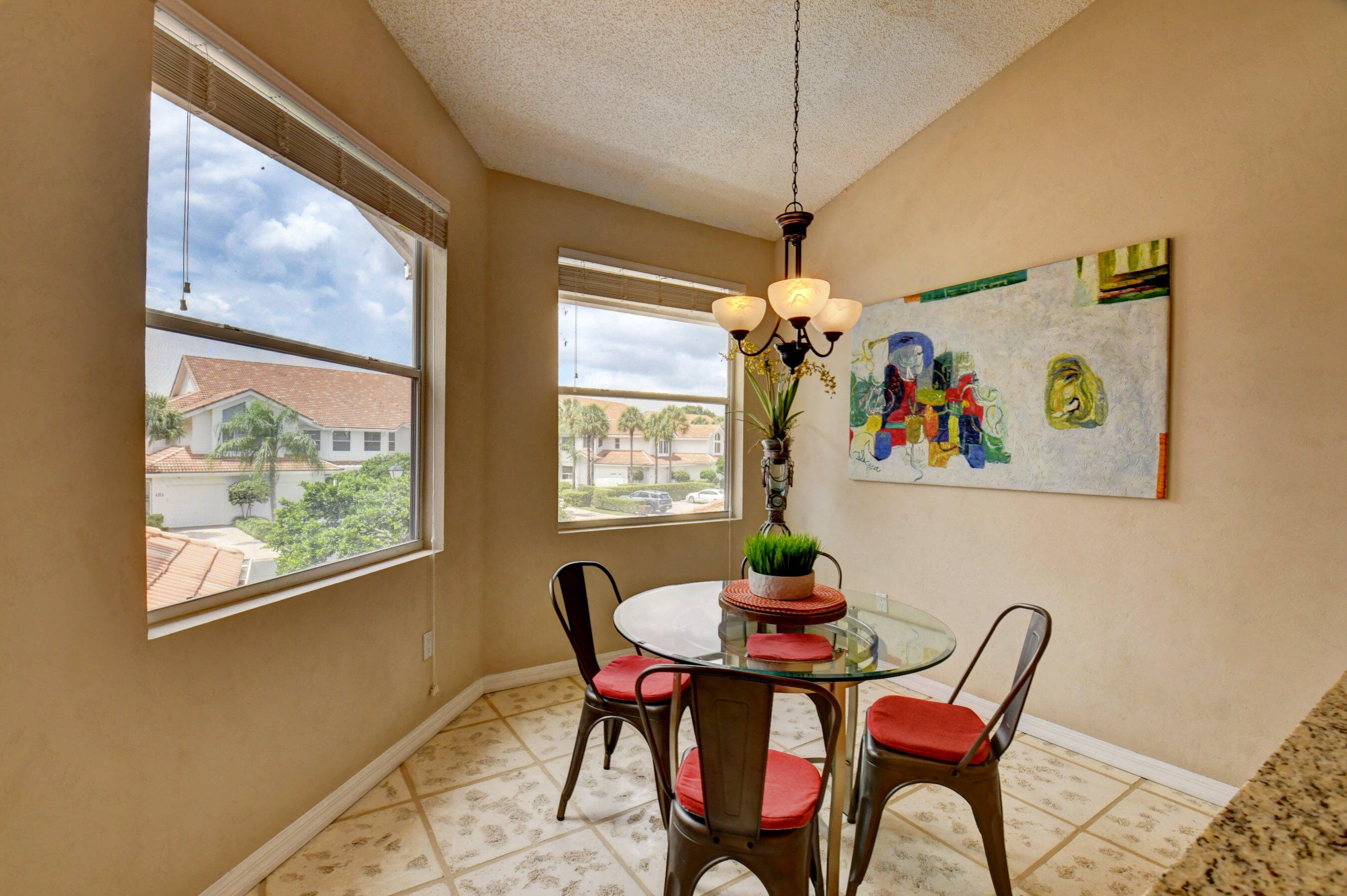 2464 Northwest 59th Street, Unit 1103 Boca Raton, FL 33496 - Photo 11 of 48 a dining room with furniture a chandelier and window