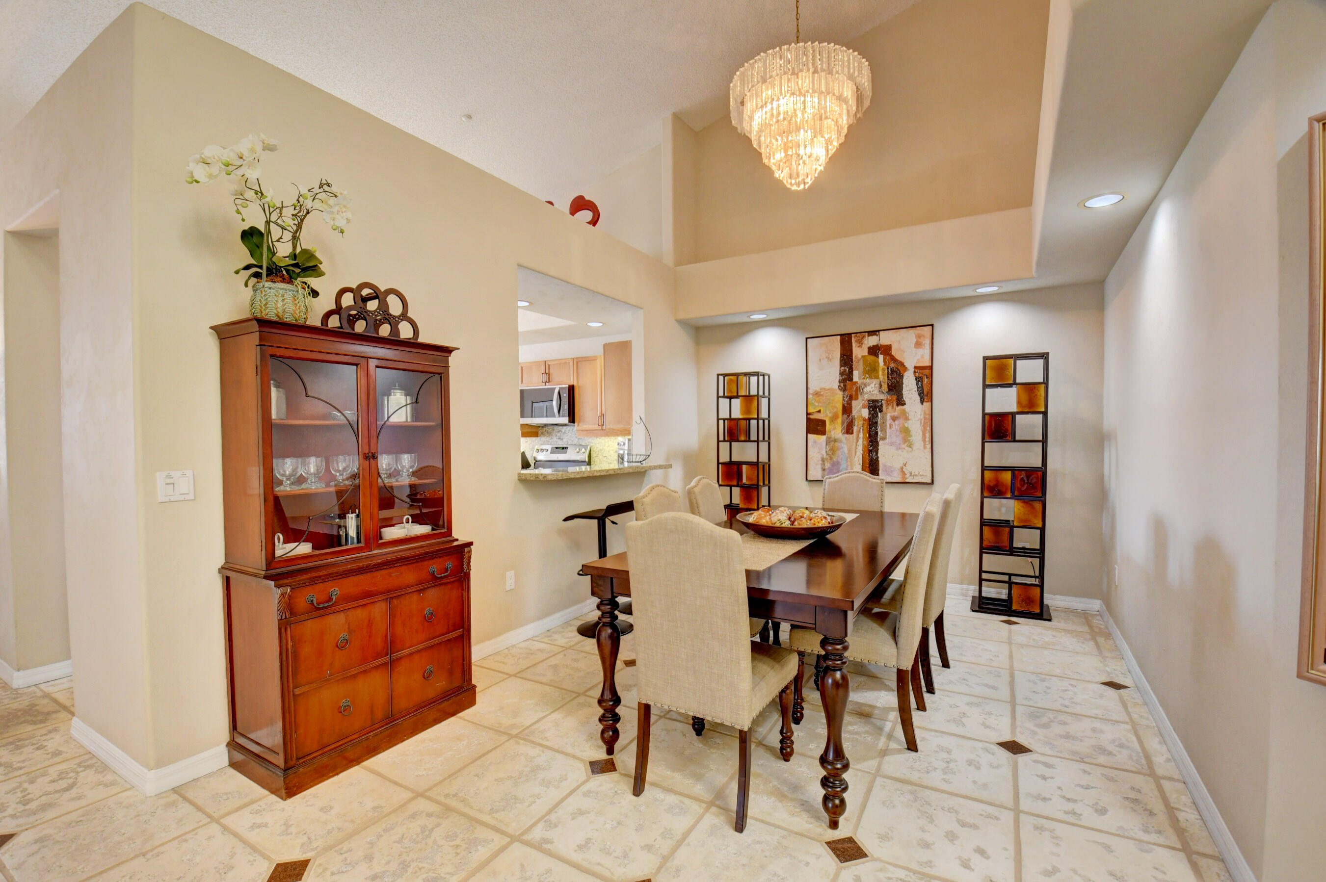 2464 Northwest 59th Street, Unit 1103 Boca Raton, FL 33496 - Photo 13 of 48 a view of a dining room with furniture and chandelier