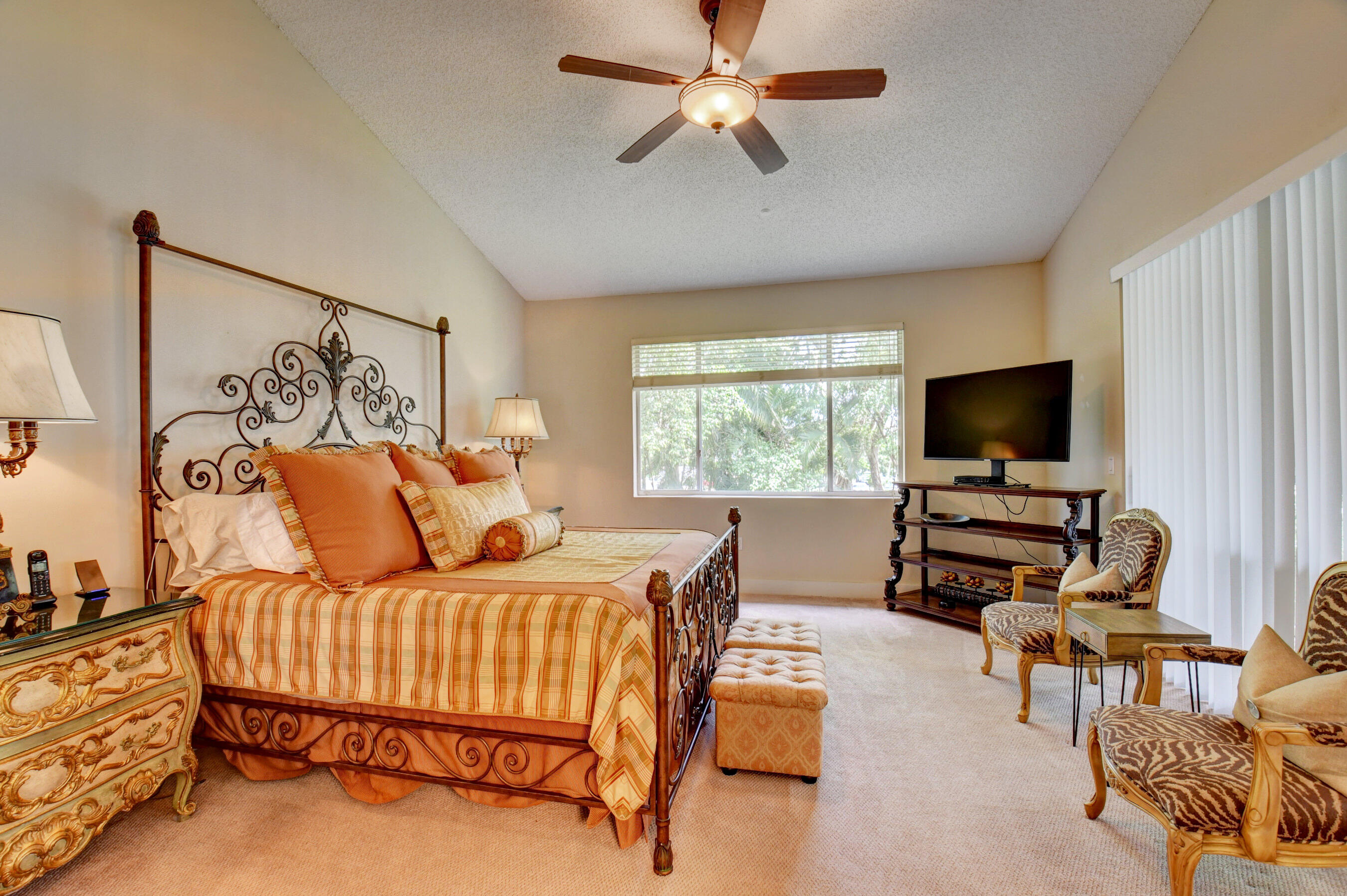 2464 Northwest 59th Street, Unit 1103 Boca Raton, FL 33496 - Photo 20 of 48 a bedroom with furniture and a flat screen tv