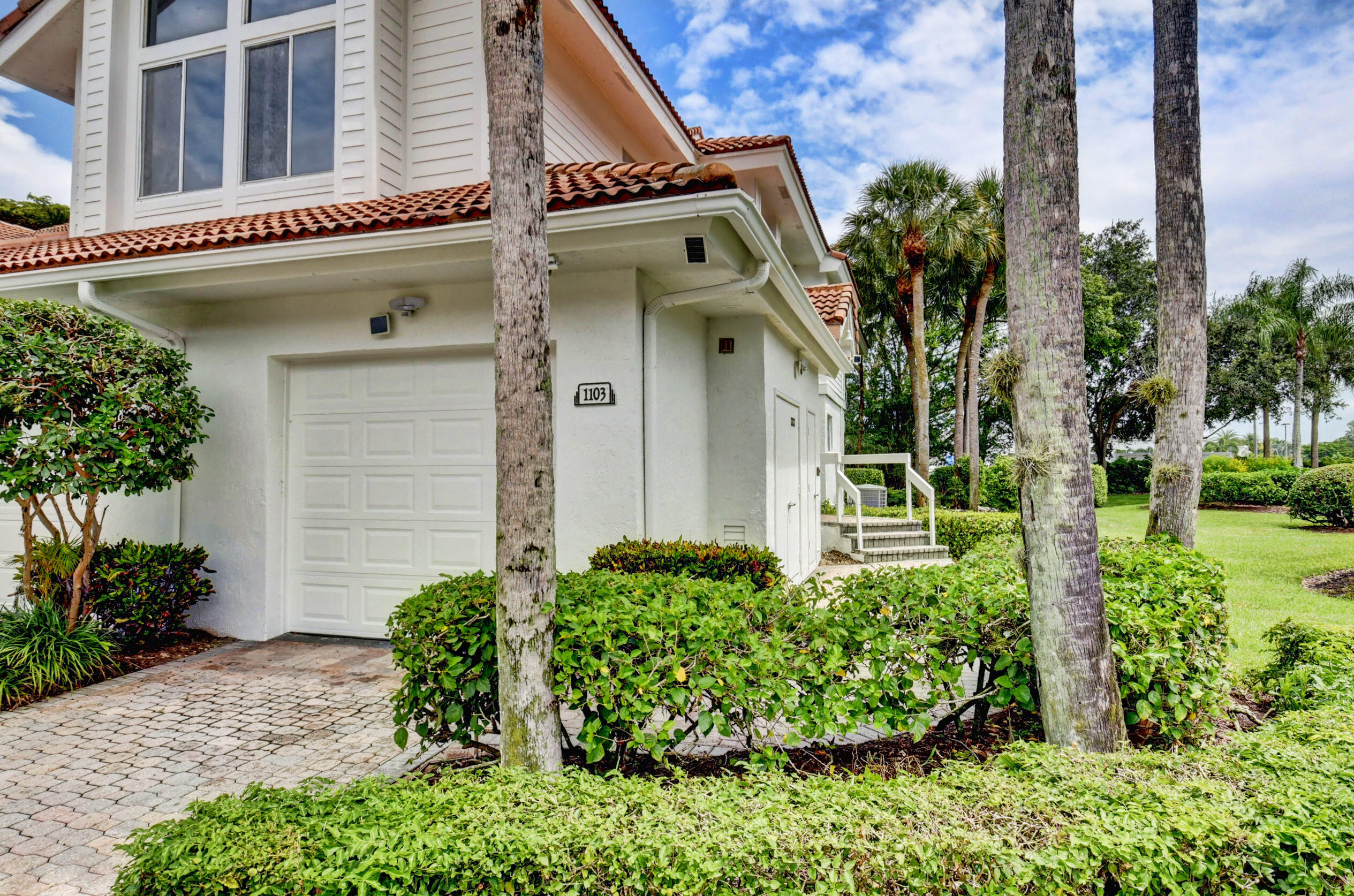 2464 Northwest 59th Street, Unit 1103 Boca Raton, FL 33496 - Photo 2 of 48 a front view of a house with garden