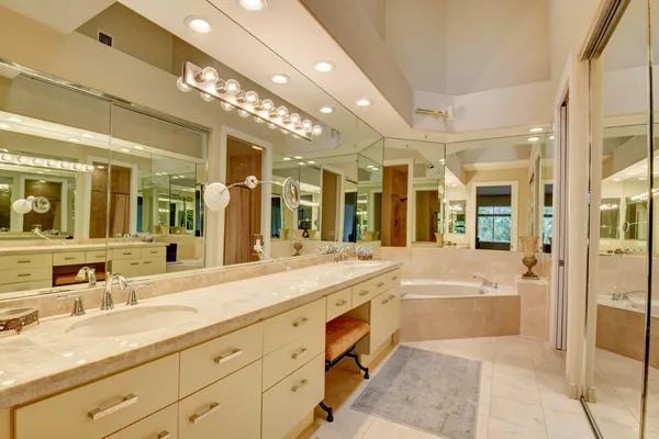 a spacious bathroom with a tub sink shower and mirror