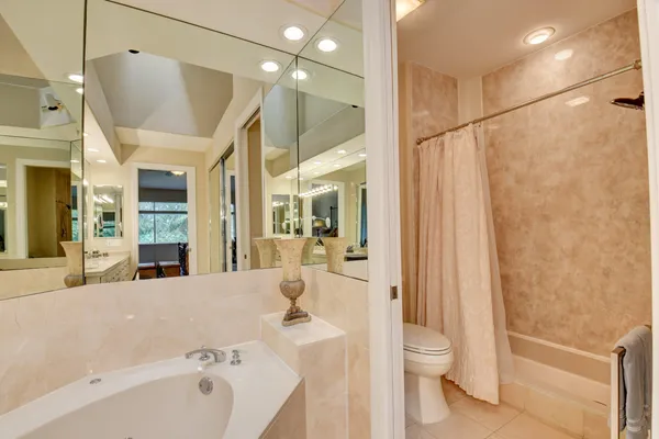 a bathroom with a bathtub shower sink and toilet