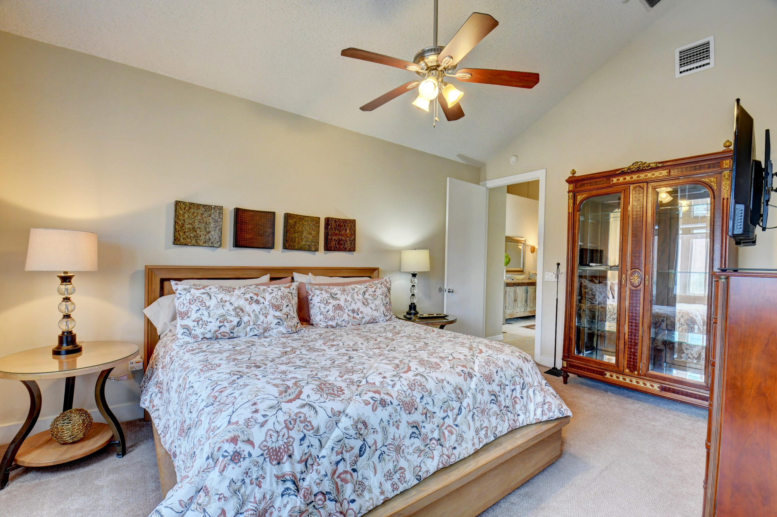 2464 Northwest 59th Street, Unit 1103 Boca Raton, FL 33496 - Photo 24 of 48 a bedroom with a large bed and a chandelier