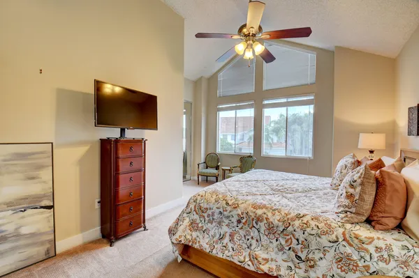 a bedroom with a bed and a flat screen tv