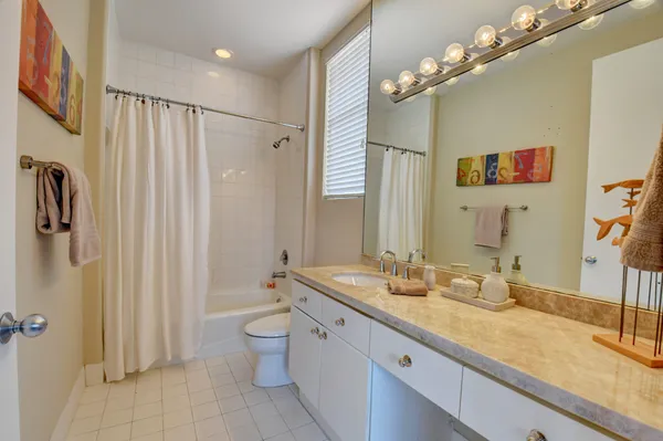 a spacious bathroom with a double vanity sink mirror and toilet