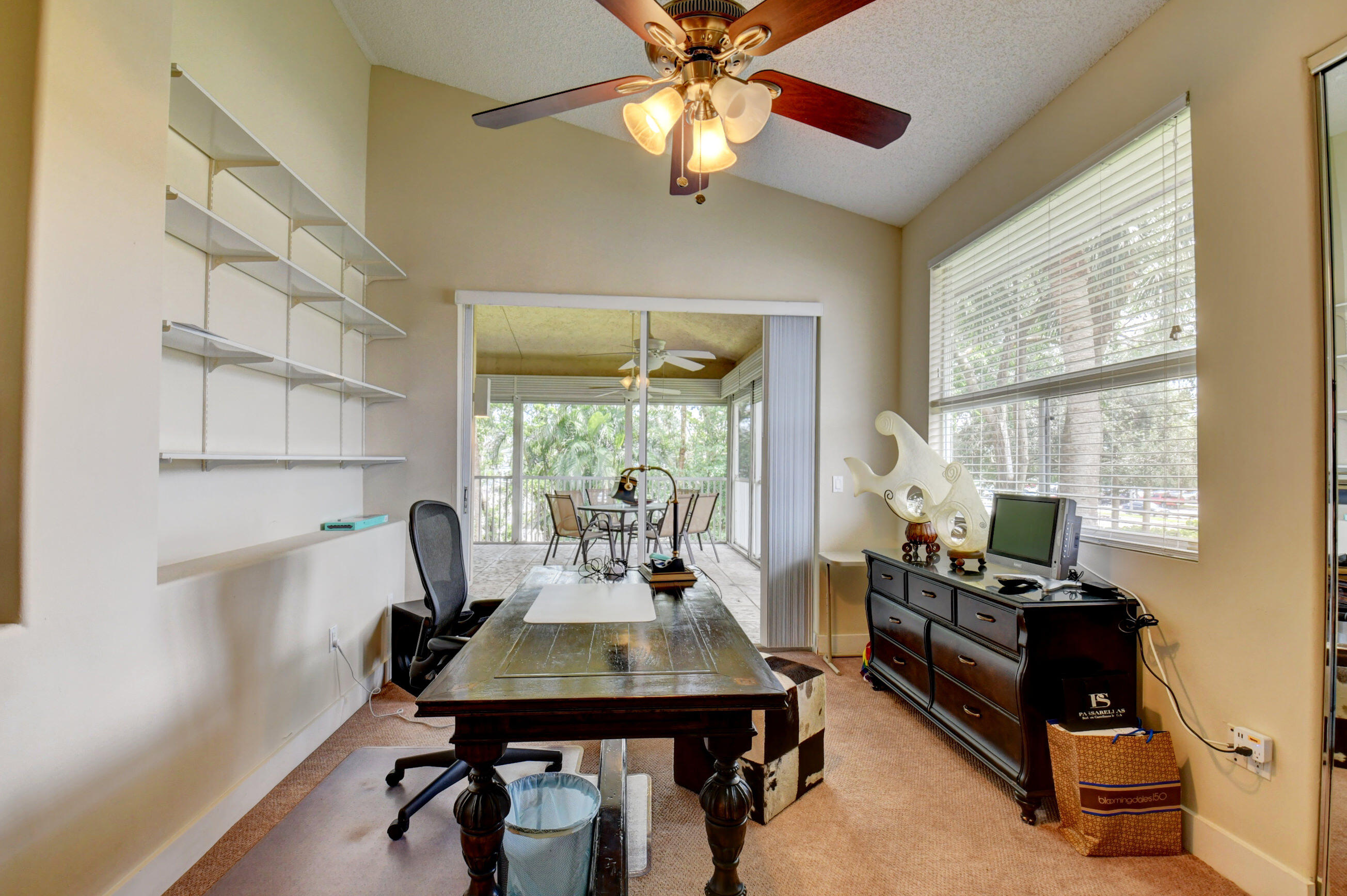 2464 Northwest 59th Street, Unit 1103 Boca Raton, FL 33496 - Photo 28 of 48 a living room with furniture a window and a chandelier