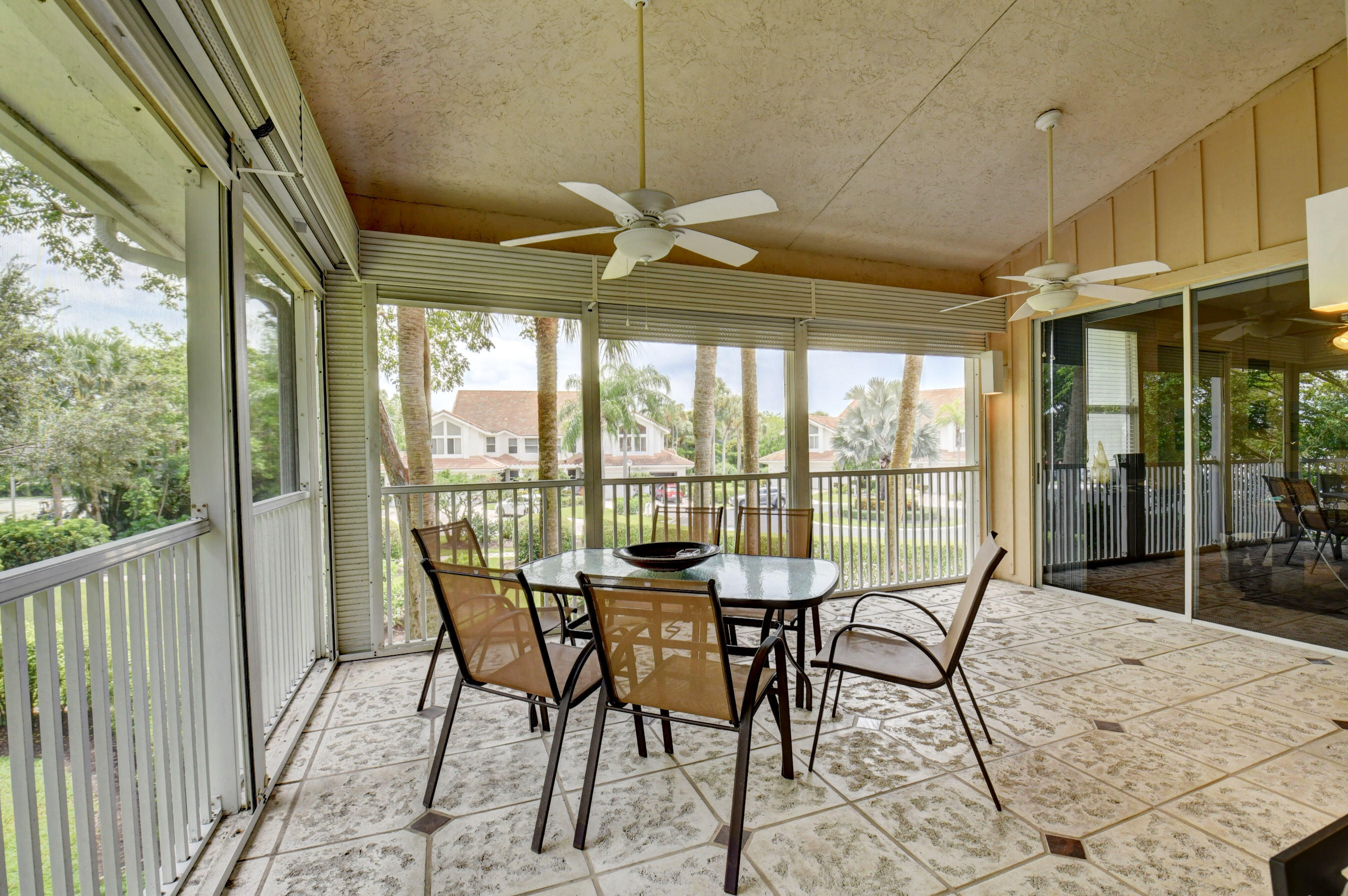 2464 Northwest 59th Street, Unit 1103 Boca Raton, FL 33496 - Photo 33 of 48 a view of a dining room with furniture large windows and wooden floor
