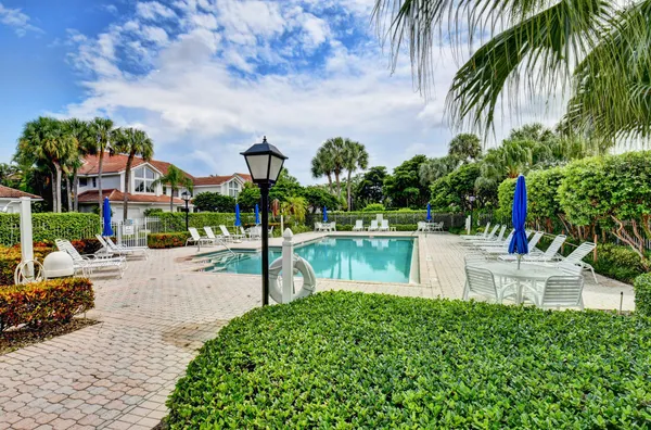 a swimming pool with outdoor seating and garden