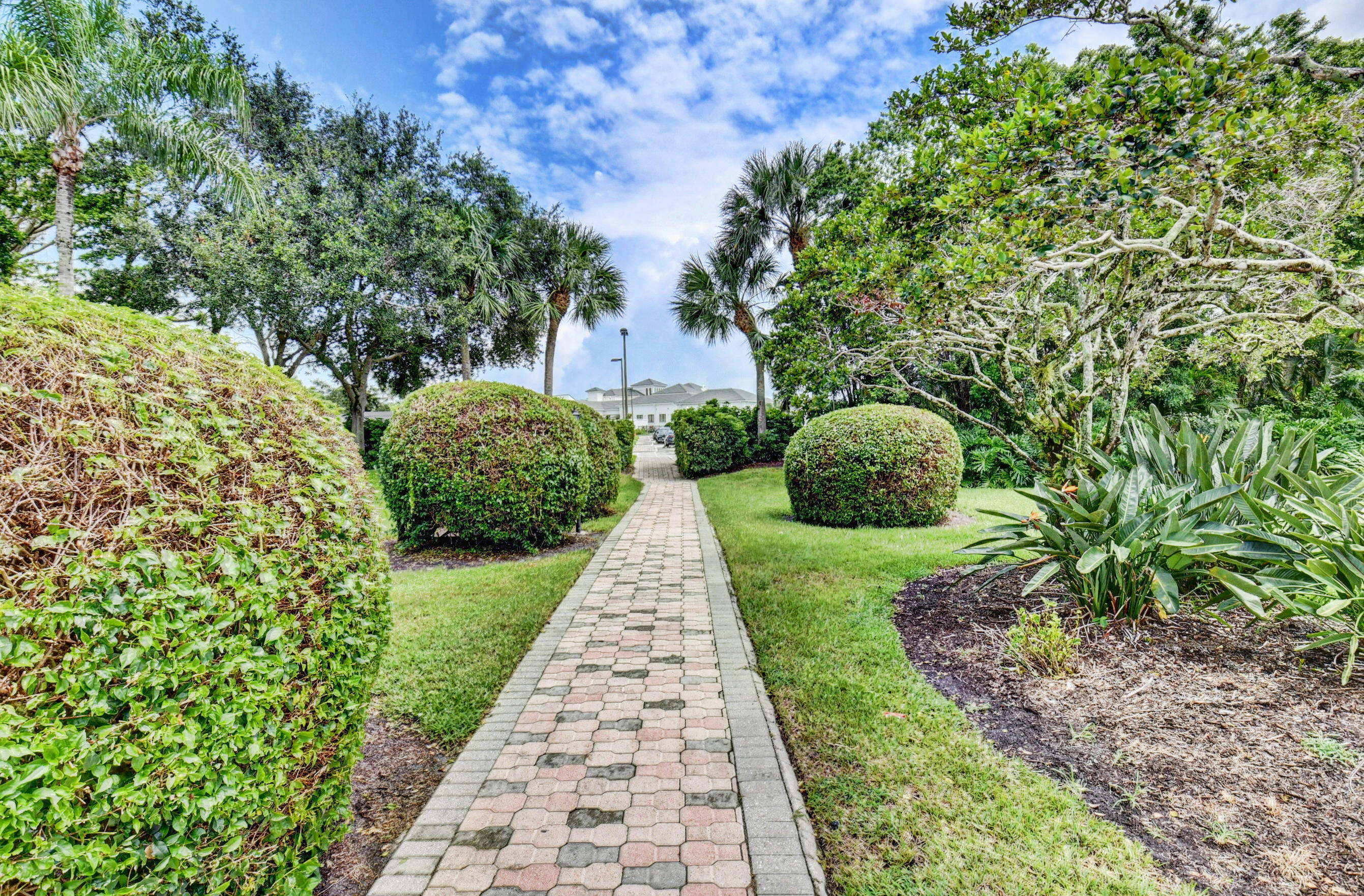 2464 Northwest 59th Street, Unit 1103 Boca Raton, FL 33496 - Photo 36 of 48 a view of a garden with pathway