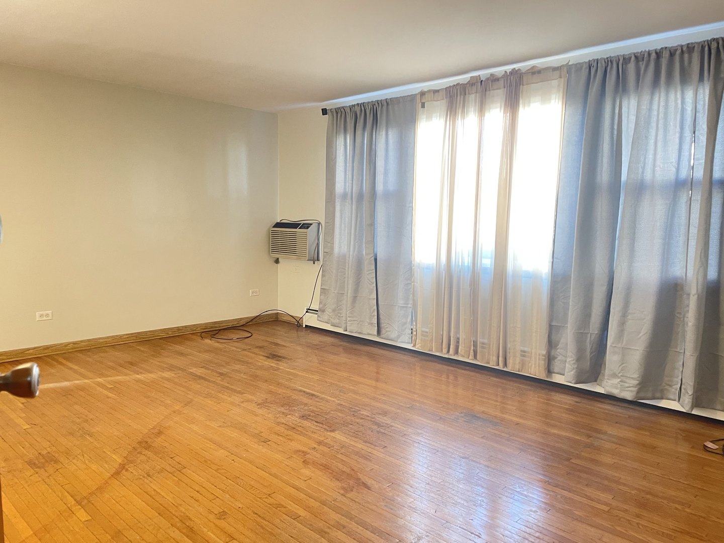 8046 South Pulaski Road Chicago, IL 60652 - Photo 3 of 9 a view of an empty room and wooden floor