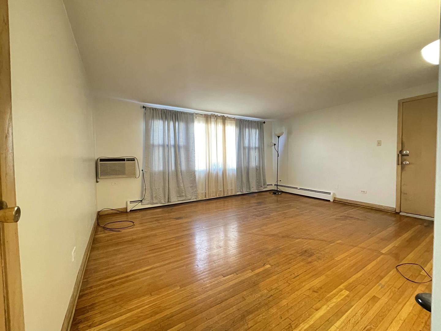 8046 South Pulaski Road Chicago, IL 60652 - Photo 8 of 9 an empty room with wooden floor and windows