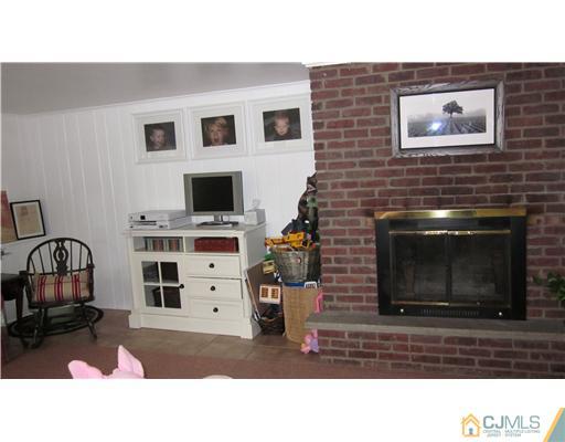 35 Clive Hills Road Edison, NJ 08820 - Photo 11 of 20 a black and white photo of a livingroom with a fireplace