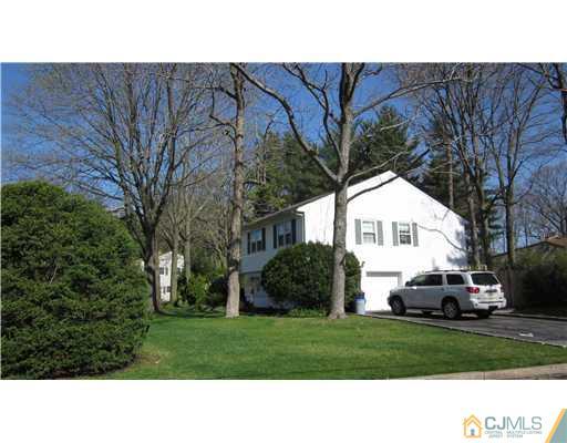 35 Clive Hills Road Edison, NJ 08820 - Photo 18 of 20 a view of a white house and a yard with a car parked in front of it