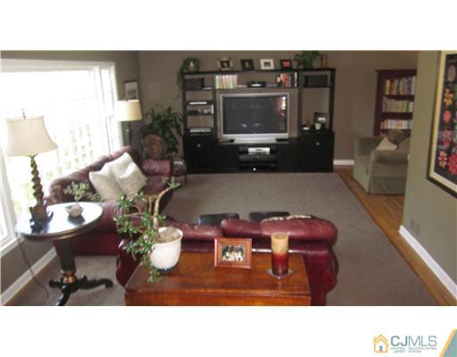 35 Clive Hills Road Edison, NJ 08820 - Photo 3 of 20 a living room with furniture and wooden floor