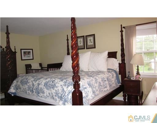 35 Clive Hills Road Edison, NJ 08820 - Photo 7 of 20 a living room with a bed and a dresser