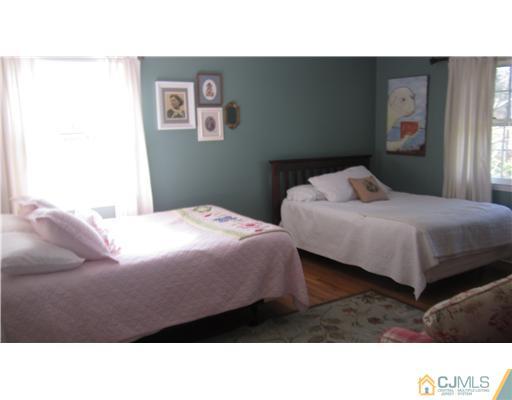 35 Clive Hills Road Edison, NJ 08820 - Photo 8 of 20 a bedroom with a bed and a painting on the wall