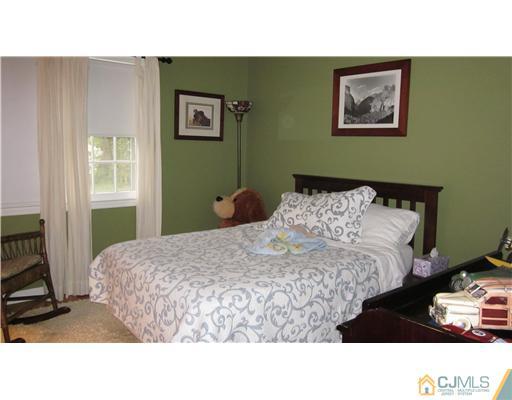 35 Clive Hills Road Edison, NJ 08820 - Photo 9 of 20 a bedroom with a bed and a window