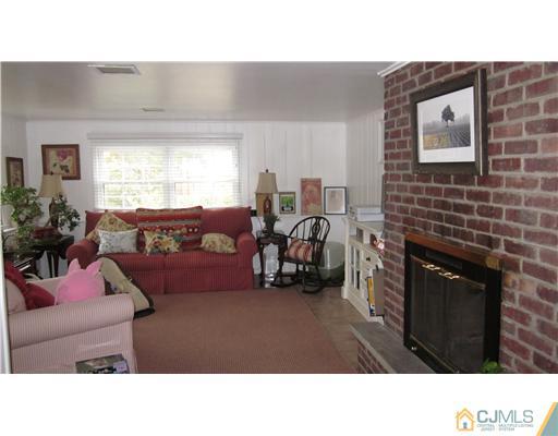 35 Clive Hills Road Edison, NJ 08820 - Photo 10 of 20 a living room with furniture and a fireplace