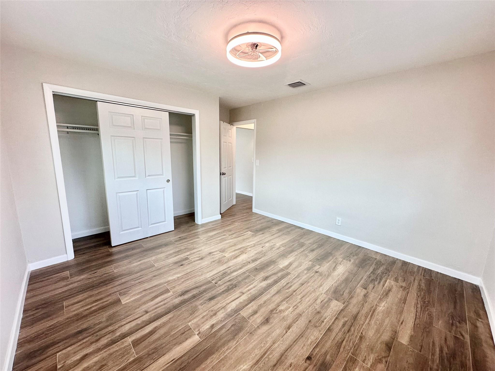 512 Southwest 11th Street, Unit A Hallandale Beach, FL 33009 - Photo 11 of 15 a view of empty room with wooden floor