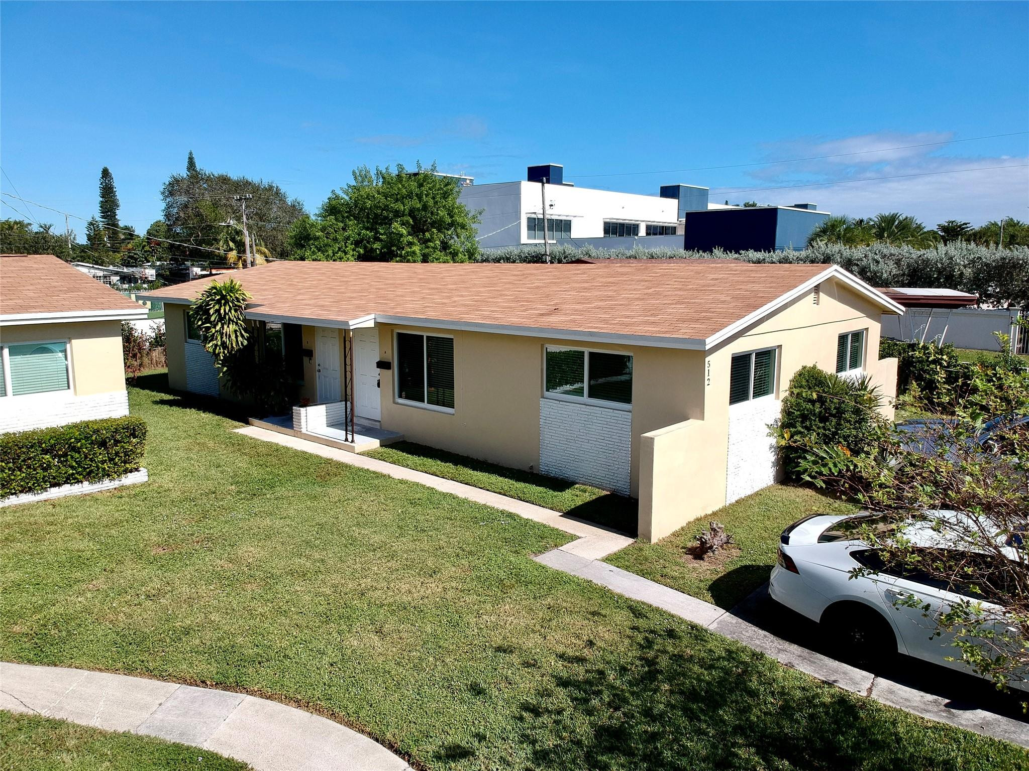 512 Southwest 11th Street, Unit A Hallandale Beach, FL 33009 - Photo 3 of 15 a aerial view of a house with a yard and garage