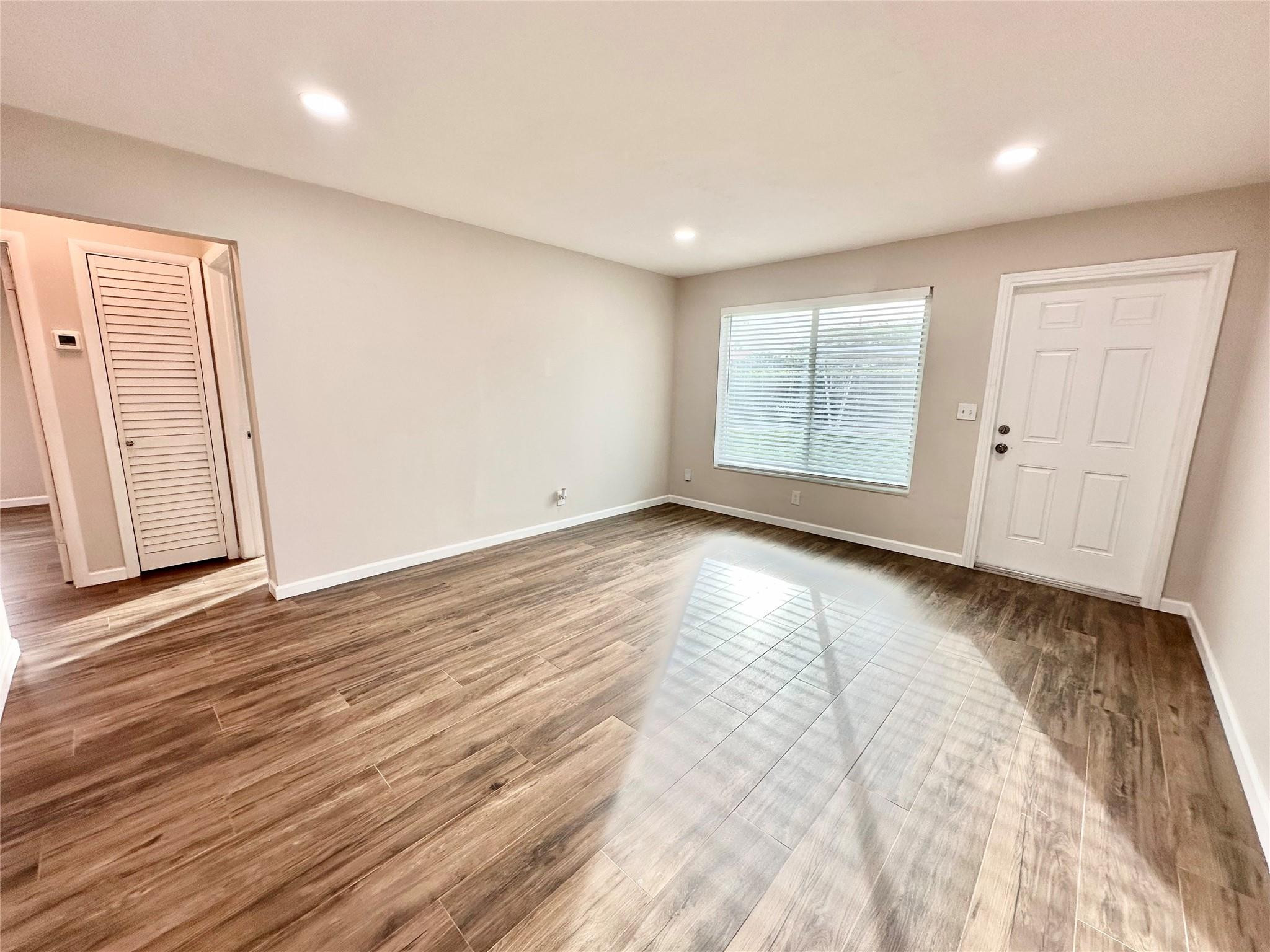 512 Southwest 11th Street, Unit A Hallandale Beach, FL 33009 - Photo 4 of 15 a view of empty room with wooden floor and fan