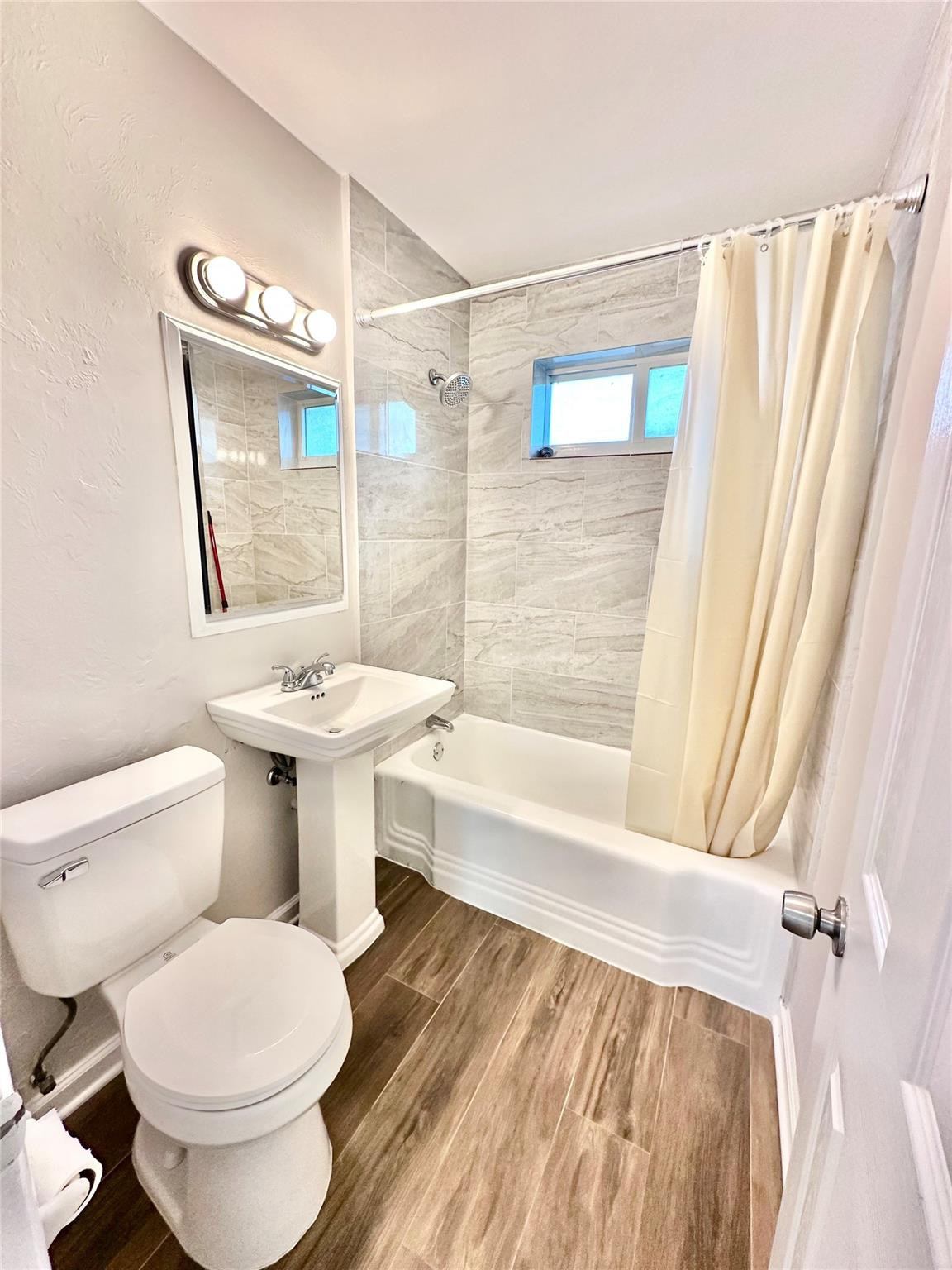 512 Southwest 11th Street, Unit A Hallandale Beach, FL 33009 - Photo 10 of 15 a bathroom with a toilet and a bathtub