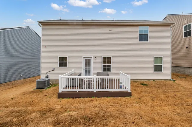 a view of roof deck with two chairs and wooden floor