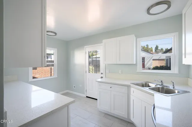 an empty room with a window and wooden floor