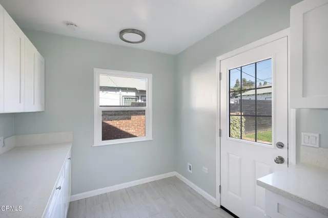 a kitchen with a sink a stove and cabinets