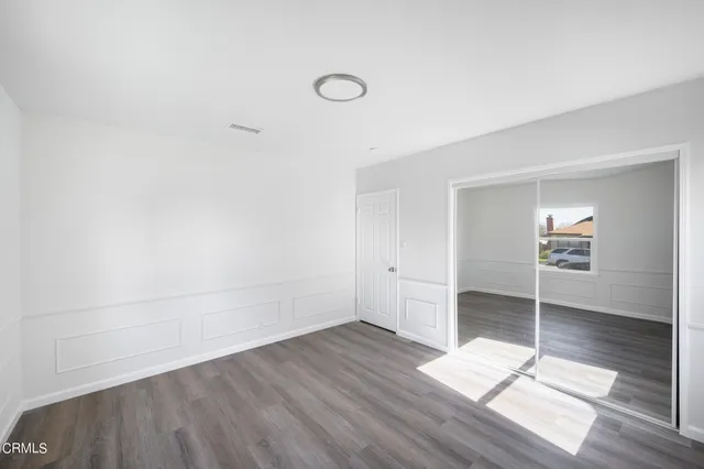 a view of cabinets and wooden floor