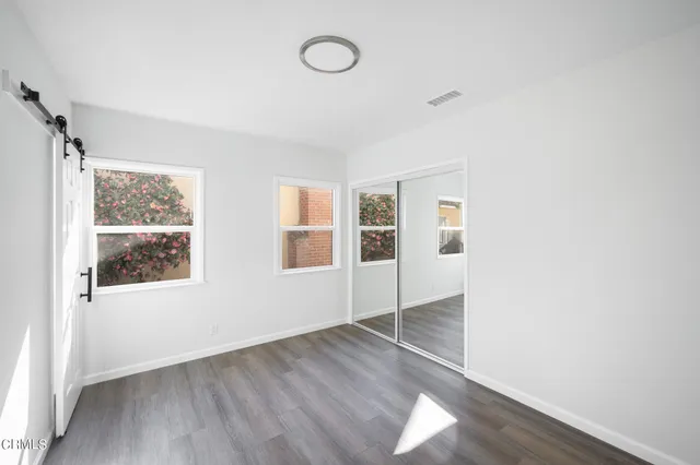 a view of a room with wooden floor and window
