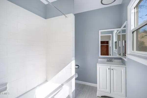 a bathroom with a bathtub and a shower