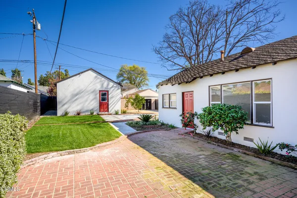 a front view of a house with a garden and garage